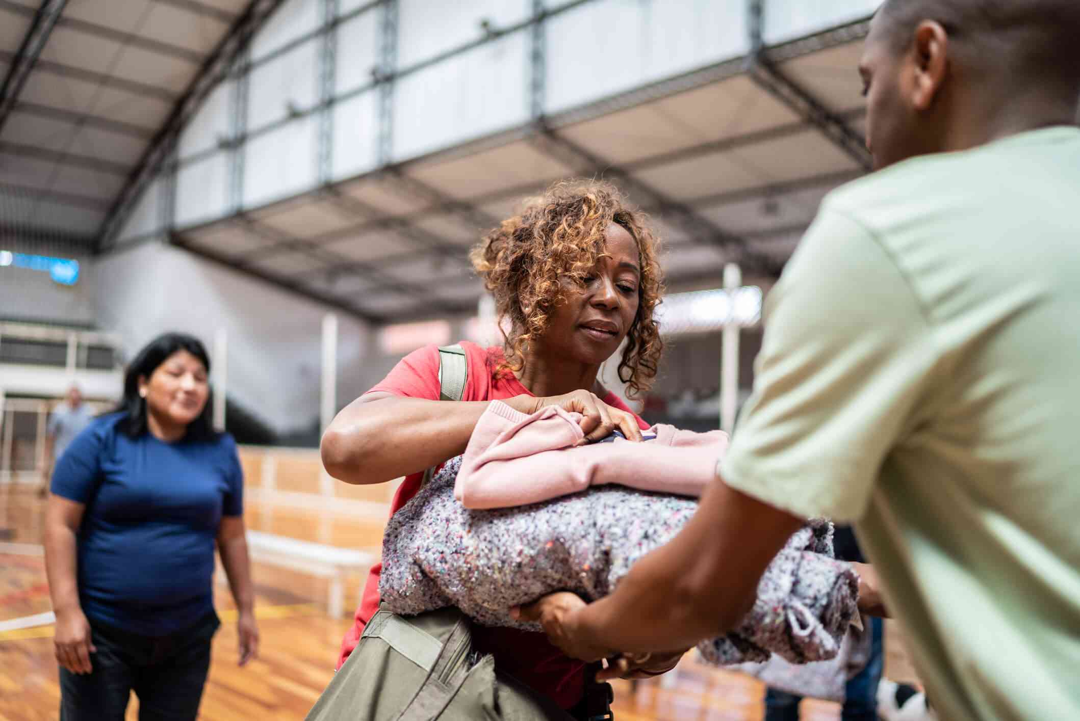 Woman giving clothes to a man