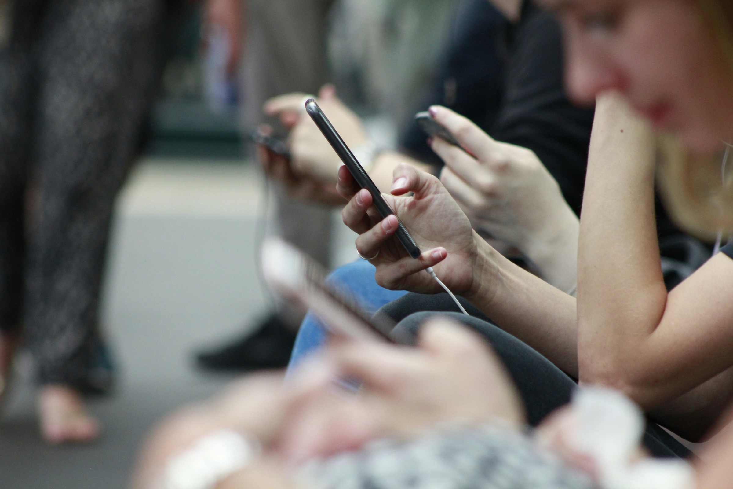 Person Holding Black Phone people on their phone